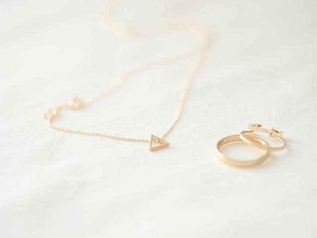 Minimalist gold jewelry, simple rings, delicate necklaces, and stud earrings